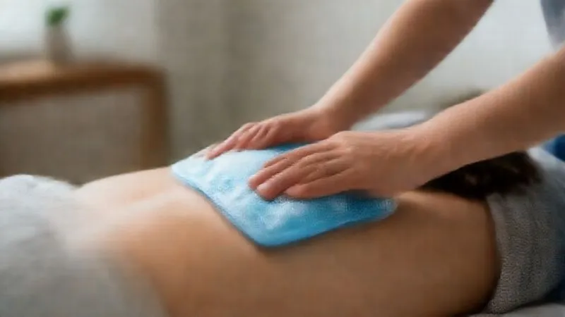 A photorealistic close-up of a person gently applying an ice pack to their lower back while lying in a comfortable, supportive position, with a soft, blurred home environment in the background. Cinematic lighting, sharp focus on the ice pack and back area, depth of field, 8K hyper-detailed, shot on a high-end DSLR.