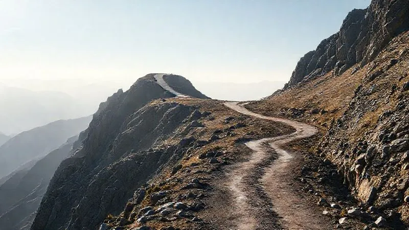 A photorealistic image showing a winding, challenging mountain path with a fork in the road, one path leading to a bright, clear summit and the other descending into shadows. The focus is on the decision point, with subtle cinematic lighting highlighting the difficult choice. 8K, sharp focus, depth of field, professional photography. A photorealistic image showing a winding, challenging mountain path with a fork in the road, one path leading to a bright, clear summit and the other descending into shadows. The focus is on the decision point, with subtle cinematic lighting highlighting the difficult choice. 8K, sharp focus, depth of field, professional photography.